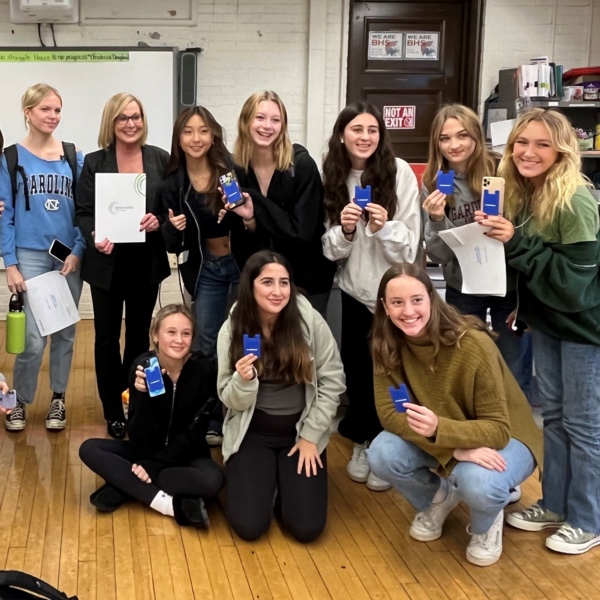 Group of girls holding up their credentials